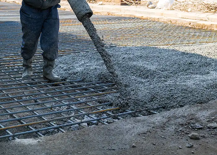 Professional directing hose to pour concrete mix for foundation - Central Illinois